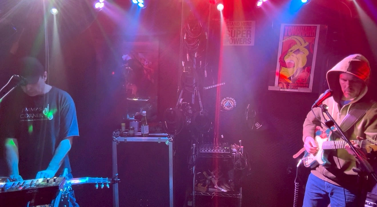 Keys and guitar mid-song in red and blue haze